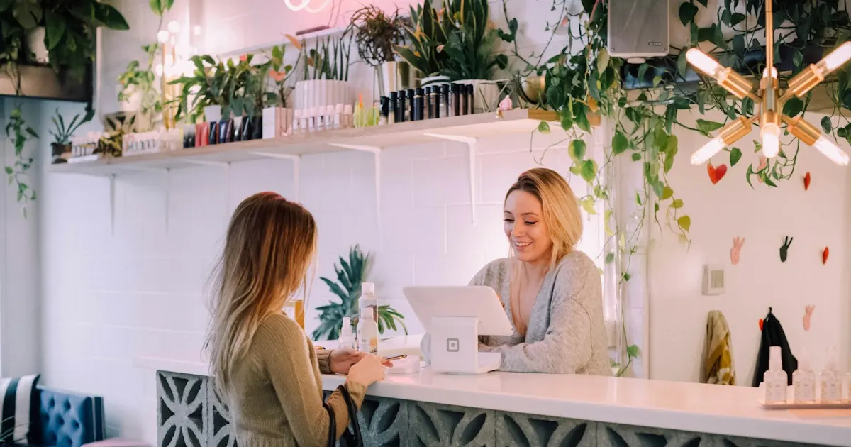 A customer paying at the counter of a small boutique shop