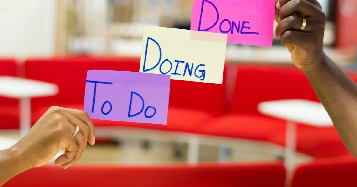 Hands holding To Do, Doing, and Done sticky notes representing a ticket workflow